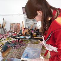 Applying a transfer onto her encaustic