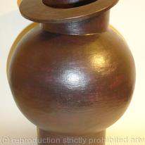 Black stoneware pot with tilted rim