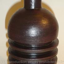 Black stoneware bottle with three ribs