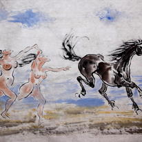 2 females chasing a horse on the beach