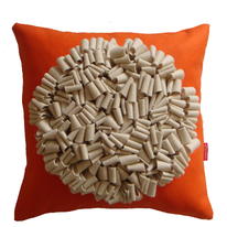cream on orange looped cushion