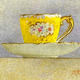 Yellow cup and saucer
